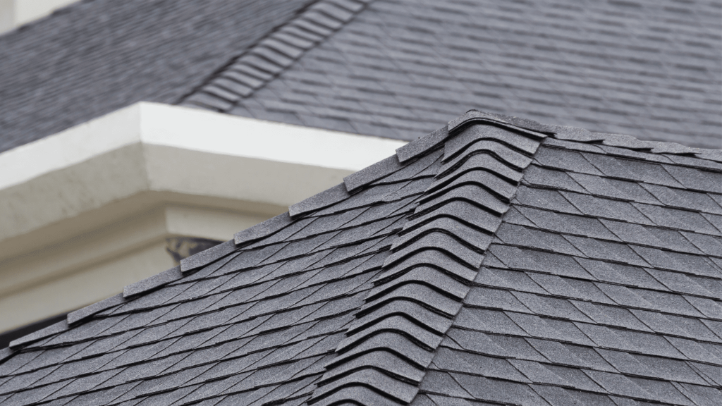 Close-up of a roof with neatly installed gray asphalt shingles.