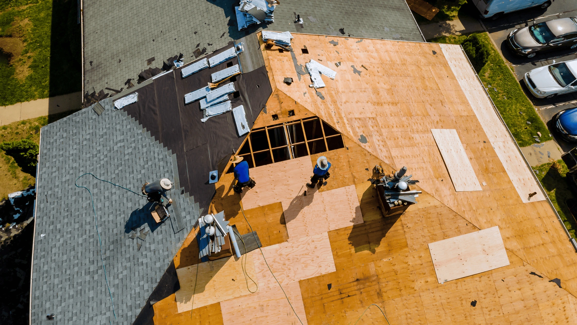 A roofer inspecting a storm-proofed roof for Asheville residential and commercial properties.
