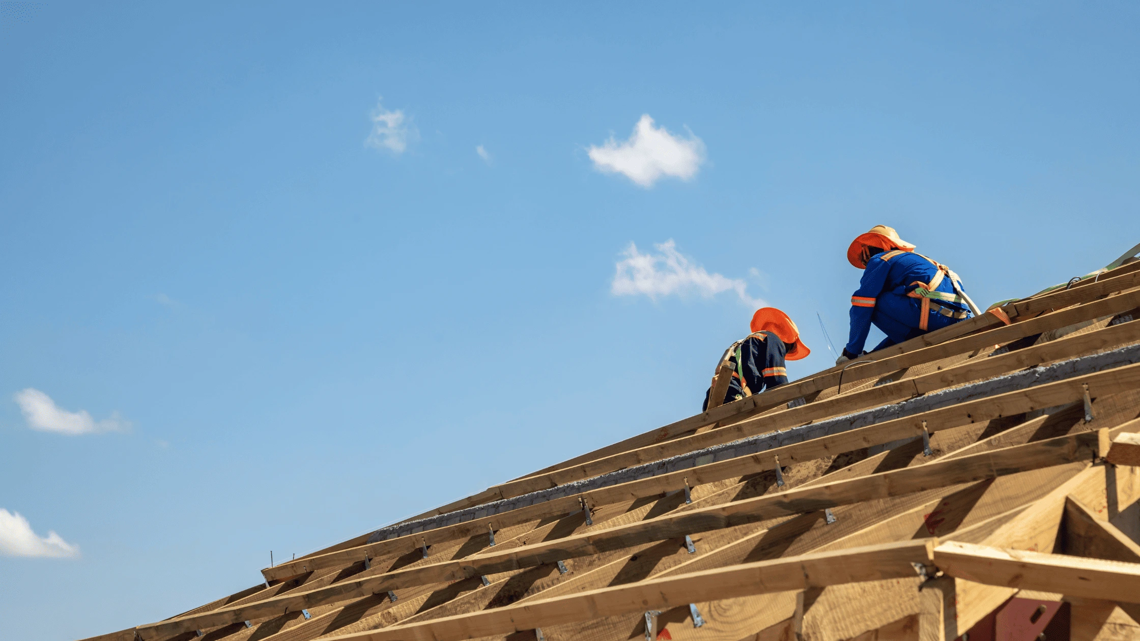 Roofers working on a roof replacement project in Asheville, demonstrating preparedness for seasonal weather challenges.