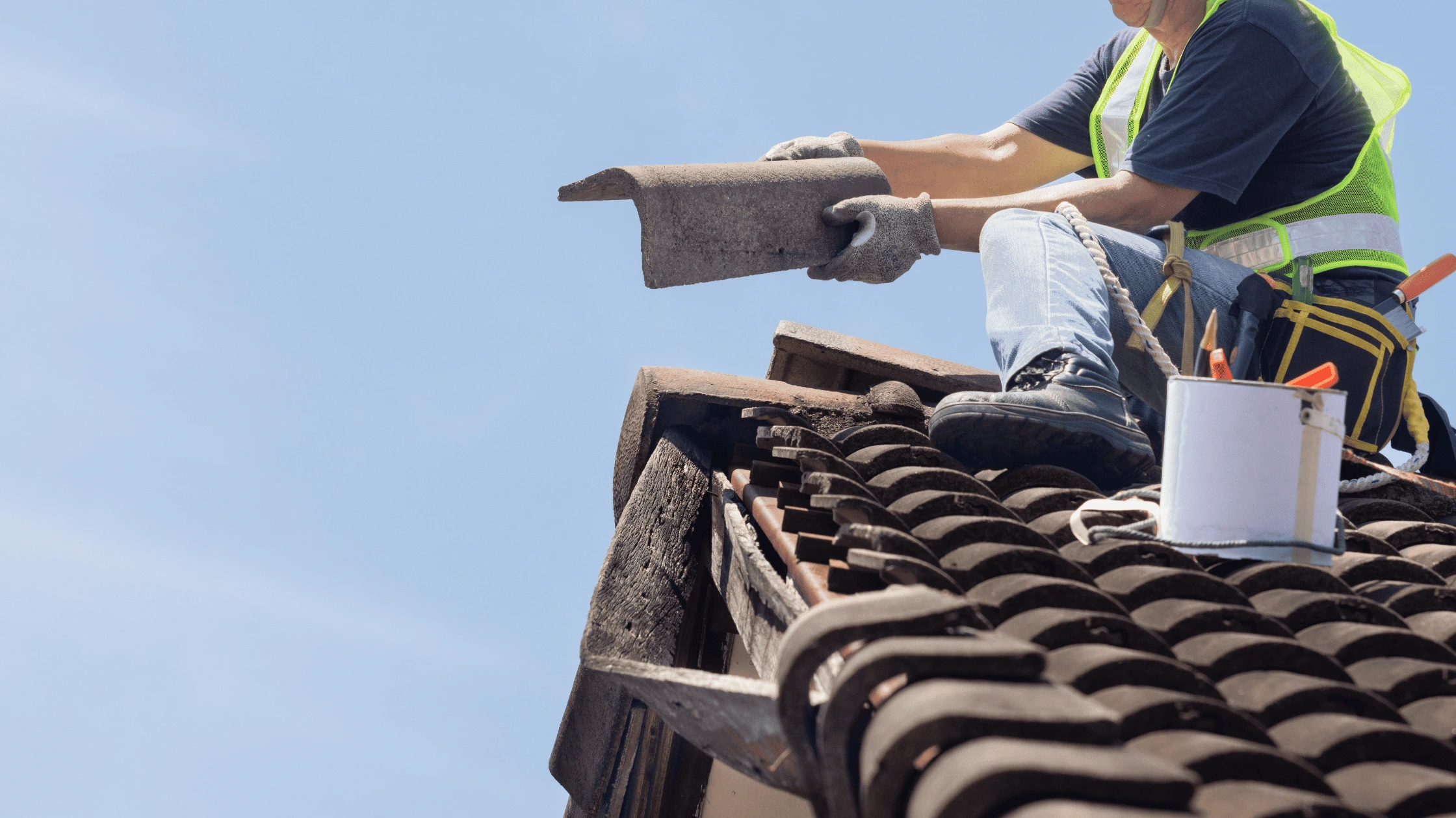 Contractor replacing damaged roof shingles, indicating signs that a reroofing project is urgently needed. Learn the warning signs before it's too late.