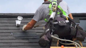 Professional roofer installing asphalt shingles on a home roof, representing roofing cost factors in Asheville, NC.